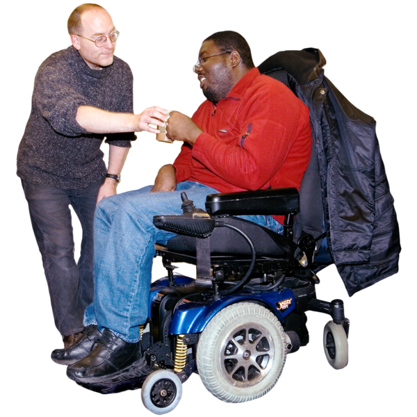 A man giving a man in a wheelchair a cup of tea. 