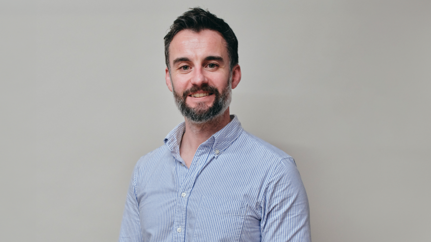 A portrait image of David, the director of Mencap Trust Company, smiling at the camera. 