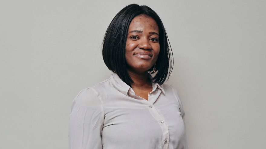A portrait image of Enna, Trust Services Officer for Mencap Trust Company, smiling at the camera. 