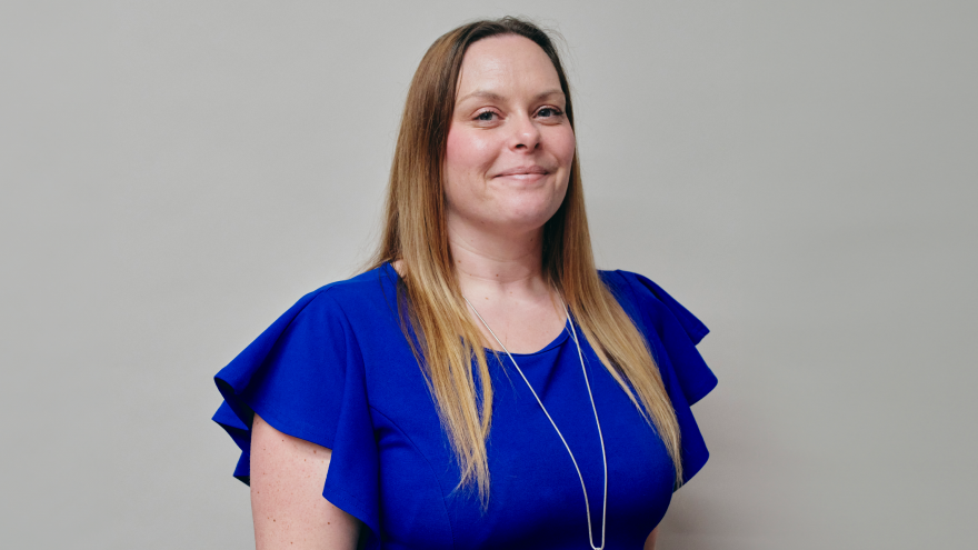 A portrait image of Stacy, Senior Trust Services Manager of Mencap Trust Company, smiling at the camera. 
