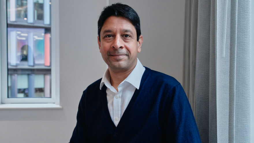 A professional headshot of Yogi Amin, the Deputy Chair of Mencap Trust Company, who is sat smiling into the camera. 