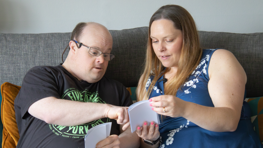 A man showing a woman some of his photographs from his holiday.